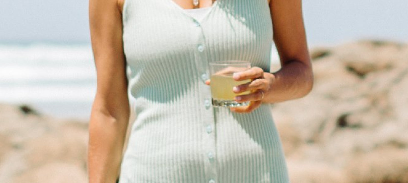 Woman at the beach enjoying a Your Super drink