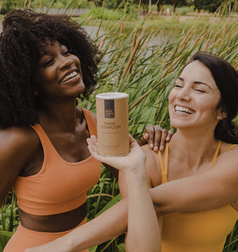 Two women posing in a field with Magic Mushroom mix